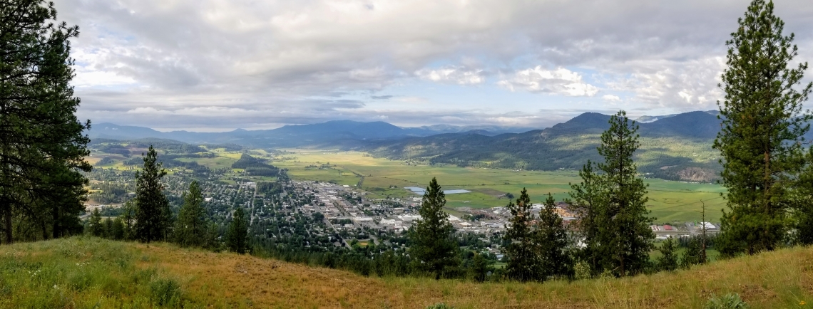 Downtown Colville in the valley between mountain ranges as soon from a mountainside above the city.