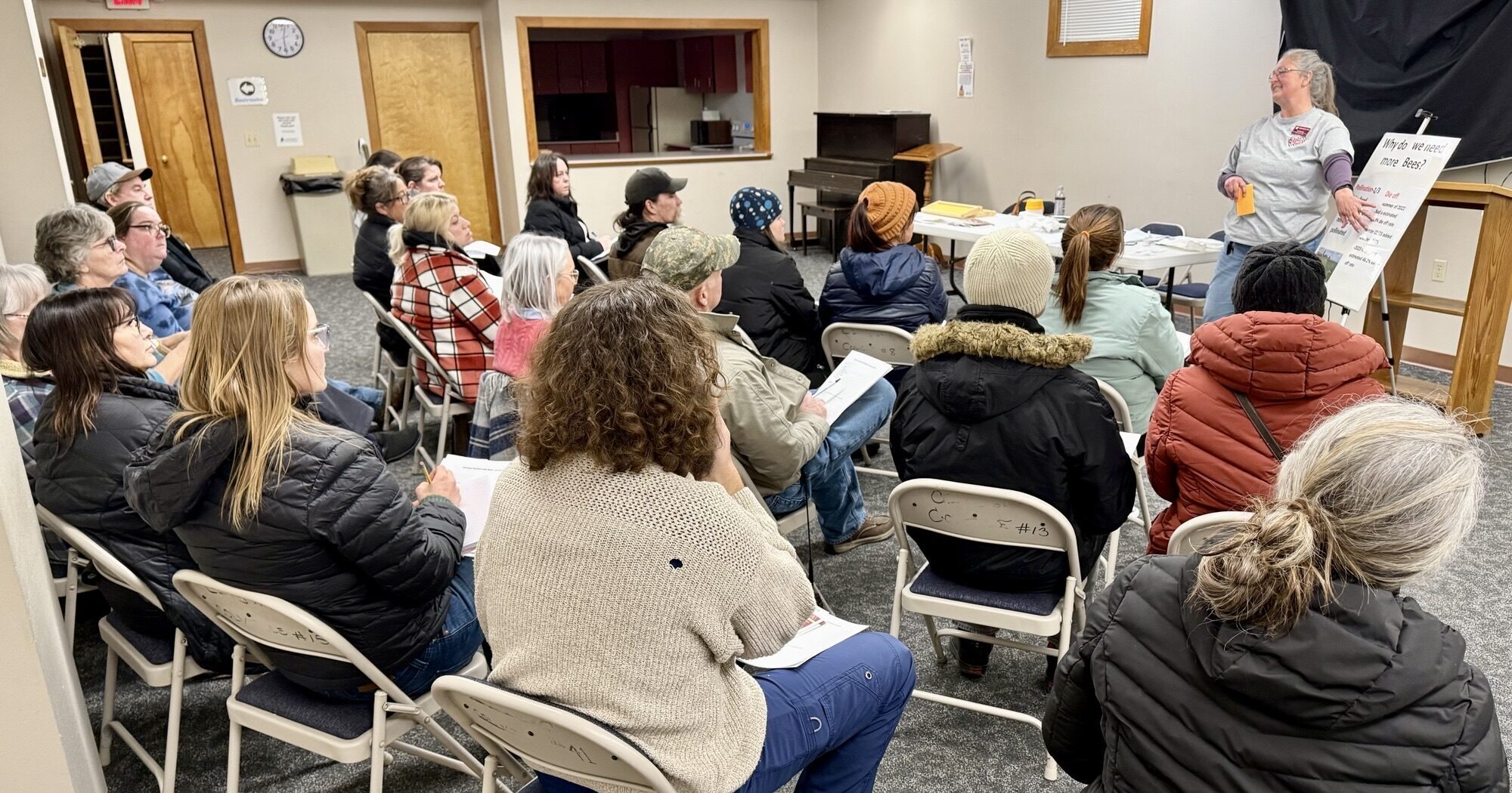 Master Gardener Suzi teaching beekeeping basics to large audience at Colville Library