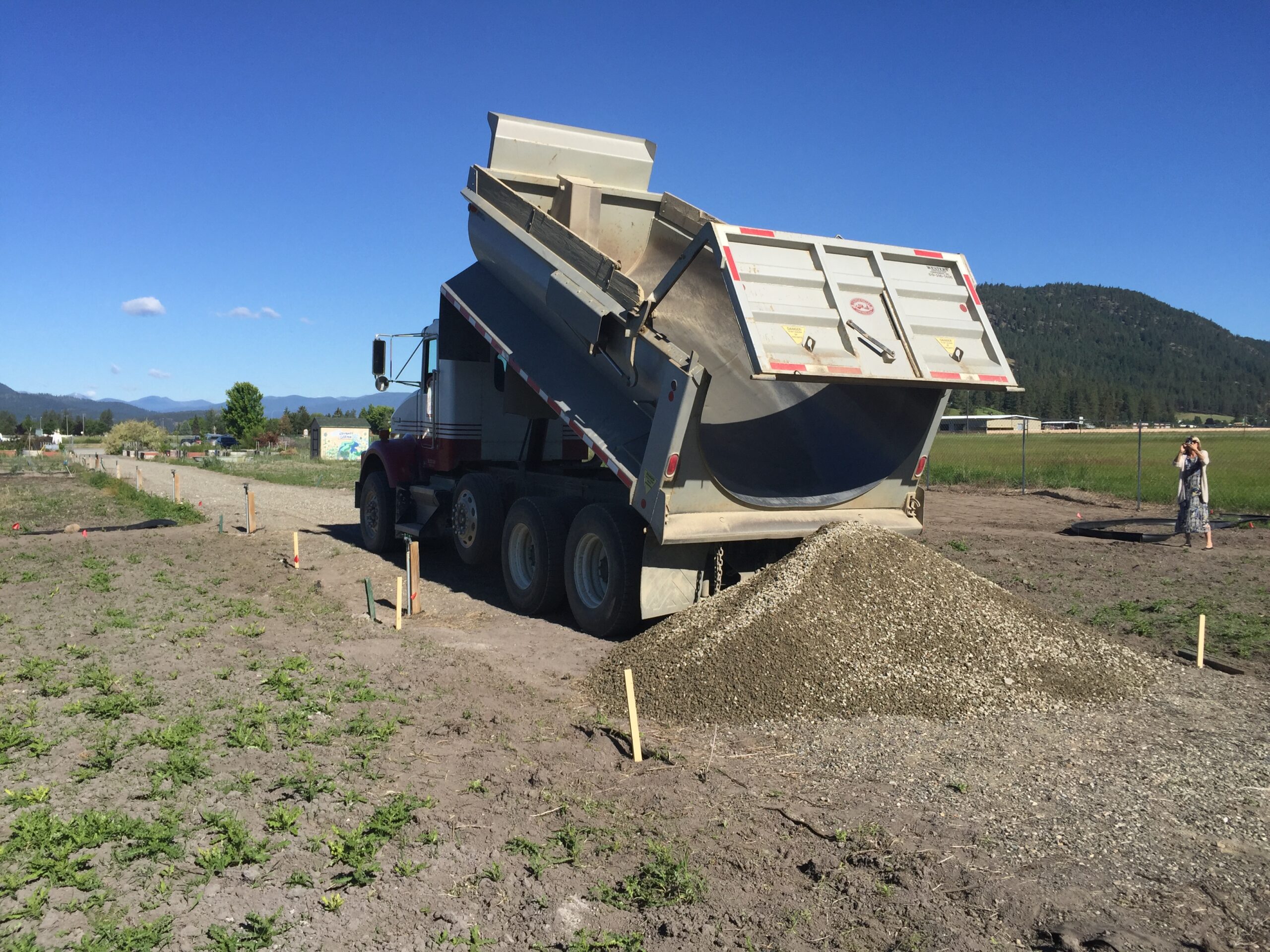 Dumptruck unloading gravel during construction of the old Firewise Demonstration Garden in Colville, WA