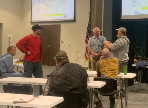 Forest owners and professionals chat during a presentation on the Armillaria pathogen at a past Forestry workshop. The upcoming Forest Owners Winter School helps owners and experts share questions, ideas, and experience.