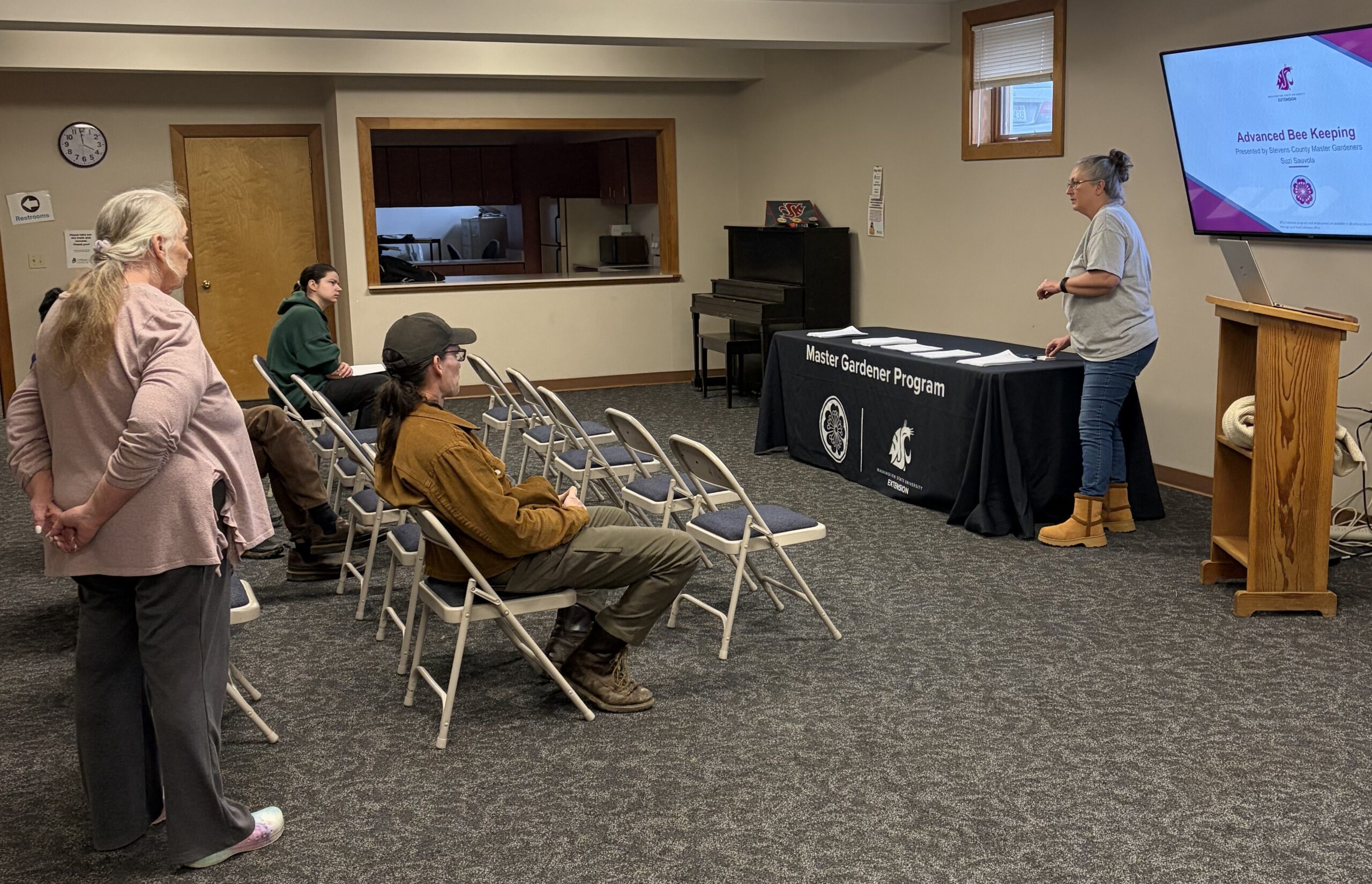 Master Gardener Suzi teaching a library class about advanced beekeeping. Master Gardener Jackie is assisting.