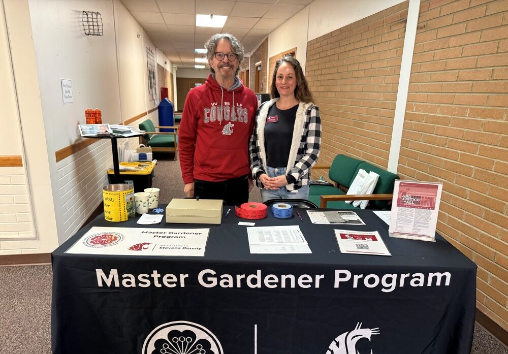 Master Gardeners Phil and Rachelle working the Registration area at the "From the Ground Up" gardening workshop