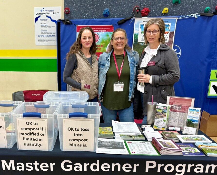 Master Gardeners Rachelle (Left) and Sheree (Right) with MG Intern Chris (middle) working at the Chewelah Home and Garden Show booth.