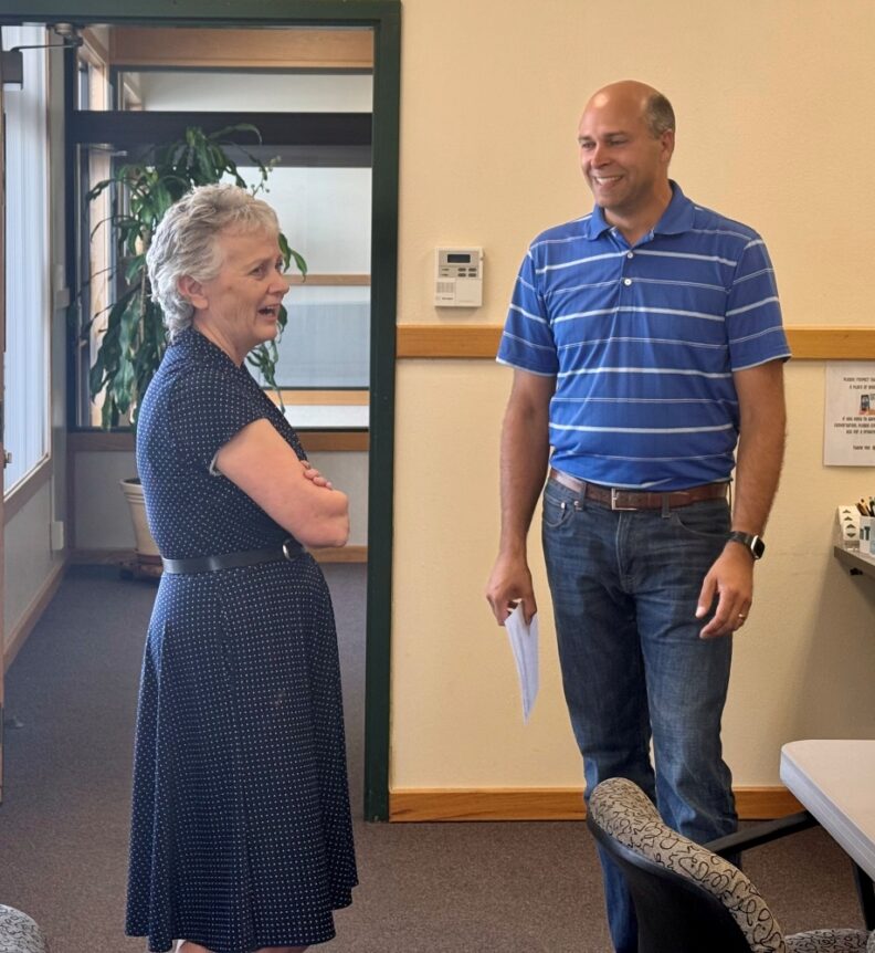 Debra Hansen chatting with Washington State Representative Andrew Engell at Debra's retirement party