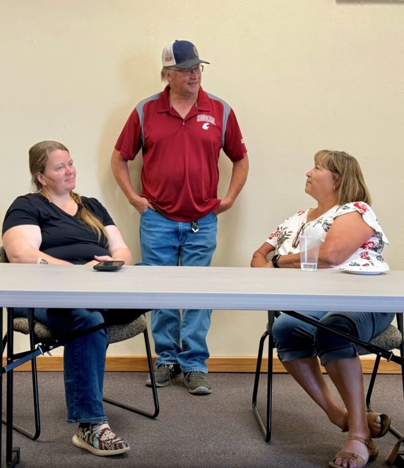 WSU Stevens County Extension Agriculture Educator Kathryn Hoogheem, Stevens County Conservation District Manager Dean Hellie, and WSU Extension Colville Reservation Director Linda McLean chatting together at Debra Hansen's Retirement Party