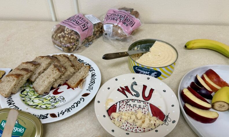 Some food served on WSU themed platters:  locally baked Sourdough bread, Cougar Gold Cheese, and Cosmic Crisp apples (variety created by WSU researchers)