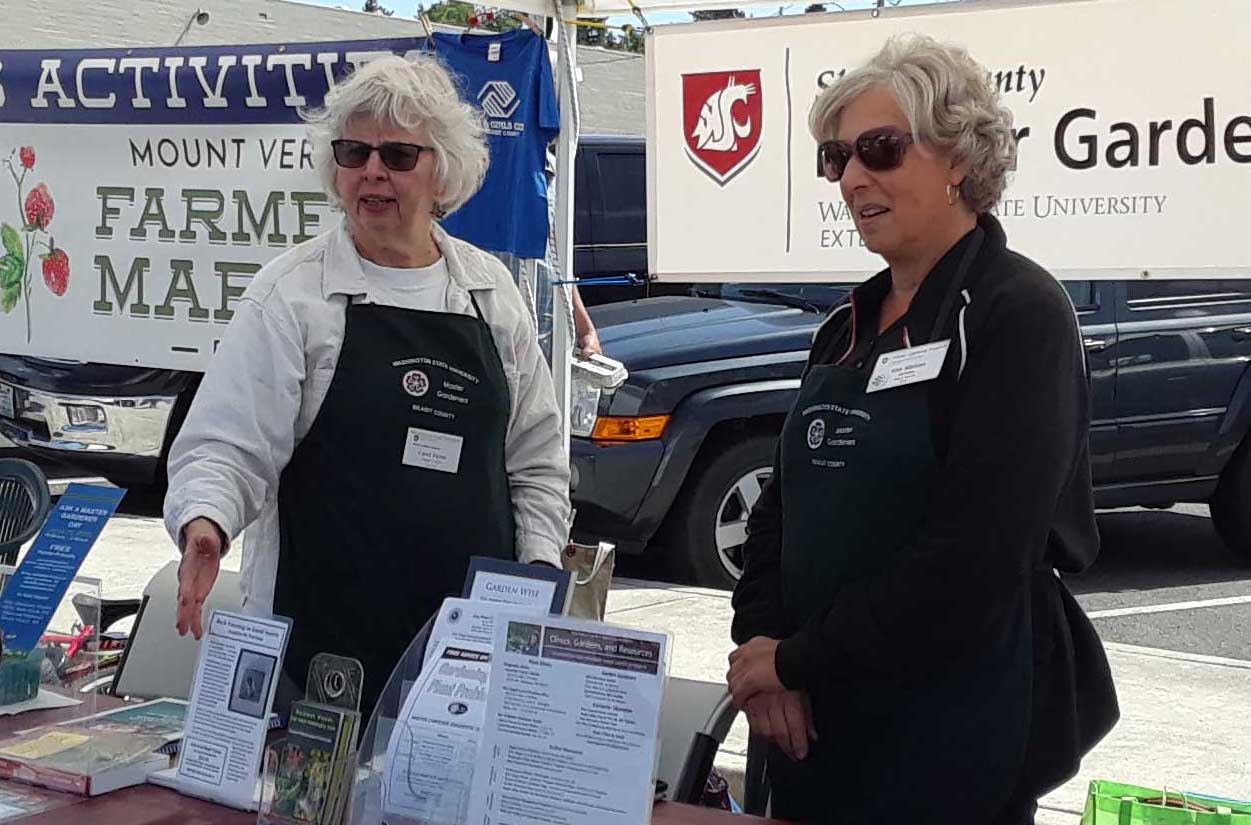 Two Master Gardener volunteers at Ask A Master Gardener booth