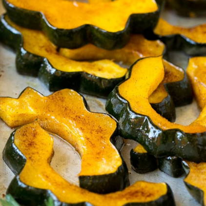 wedges of cooked acorn squash with oil and cinnamon