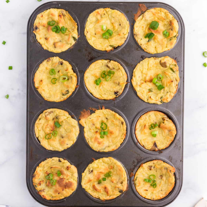 a muffin tin with potato bites, looking from above