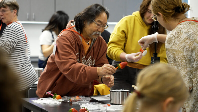 Country Living Expo Instructor demonstrates how to dip a strawberry 