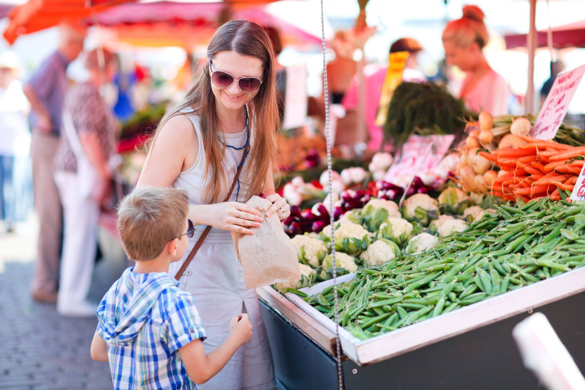 Mother and son shopping for produce
