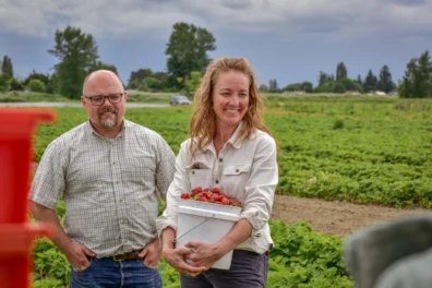 Don McMoran and Blake Van Roekel in a field of strawberries
