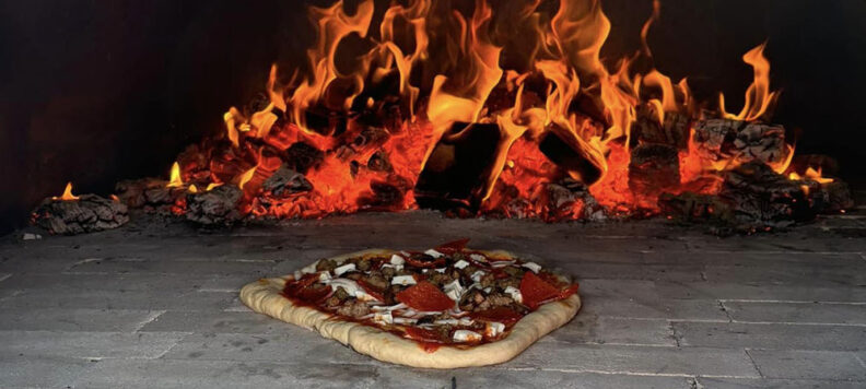 Pizza cooking in the wood wired mobile pizza oven