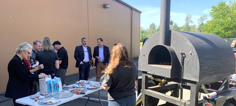 WSU President Betsy Cantwell, CAHNRS Dean Raj Khosla and the CAHNRS leadership team watch as Pizzas being made in the mobile wood fired pizza oven