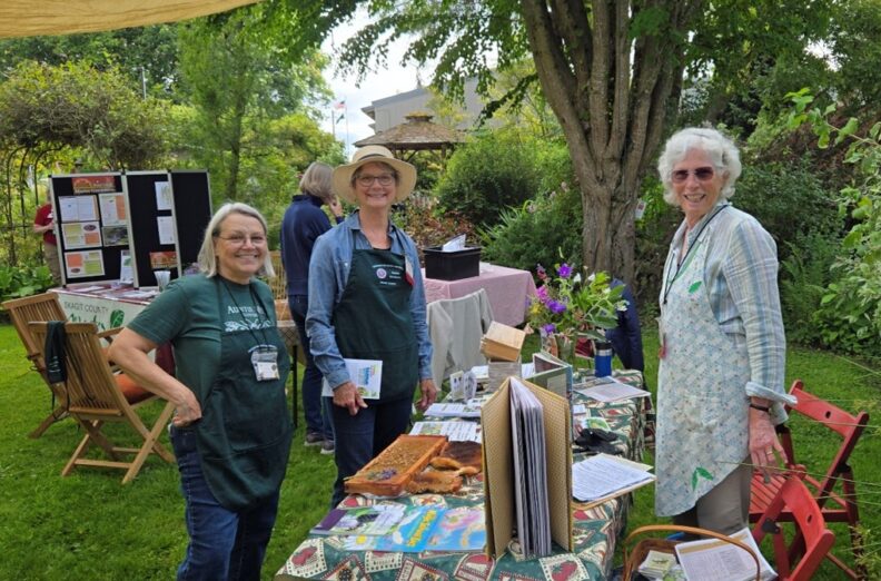 Master gardeners at outreach booth in garden