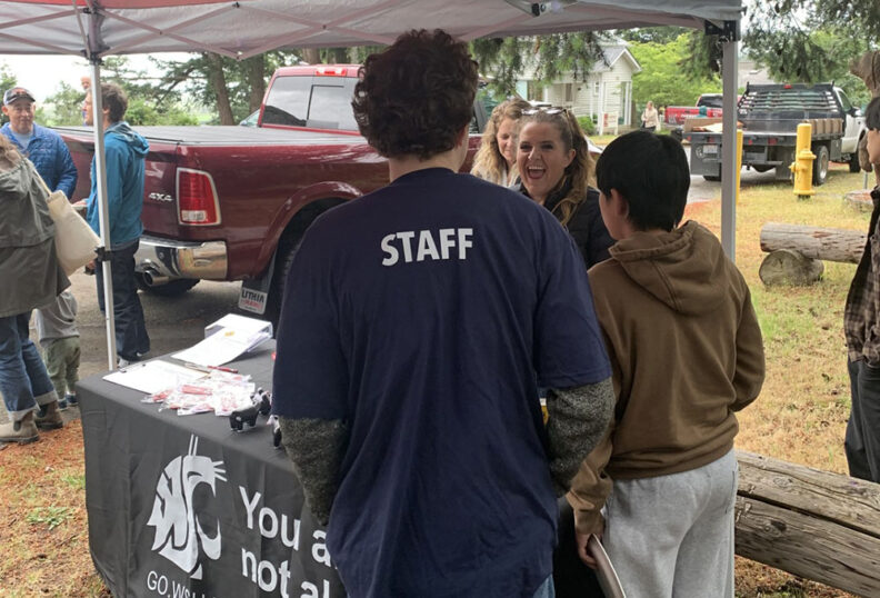 Maddie VanderKooy explains the WRASAP Farm Stress Program to visitors at the Farm Stress booth