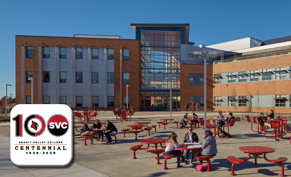 Skagit Valley College celebrating 100 years while students gather in the courtyard in front of a campus buliding