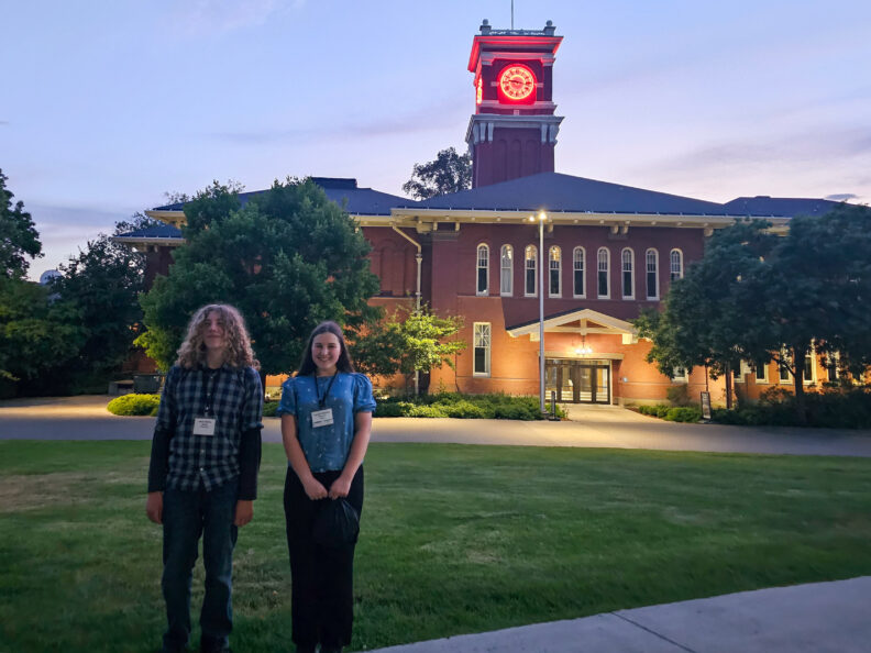 Two Skagit County teens in front of the WSU Bryan Hall clock 