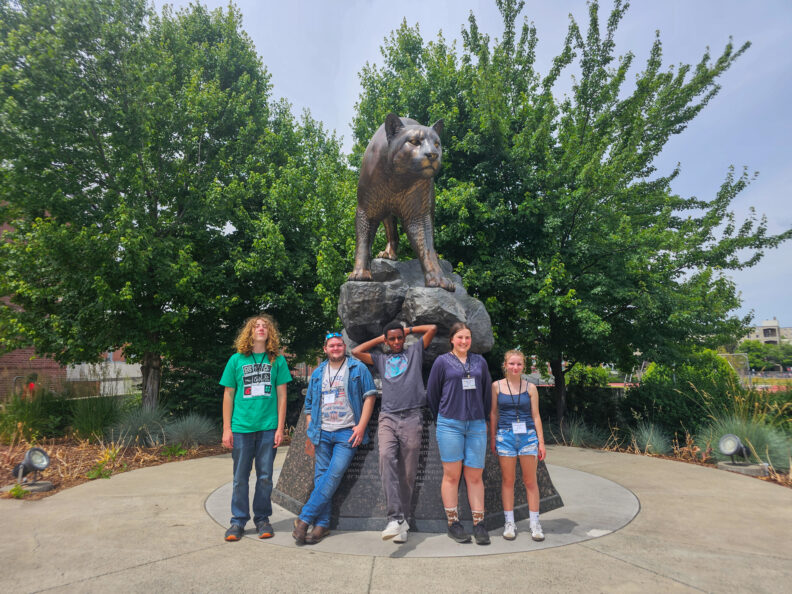 Skagit County 4-H teens in front of the WSU Cougar statue. 