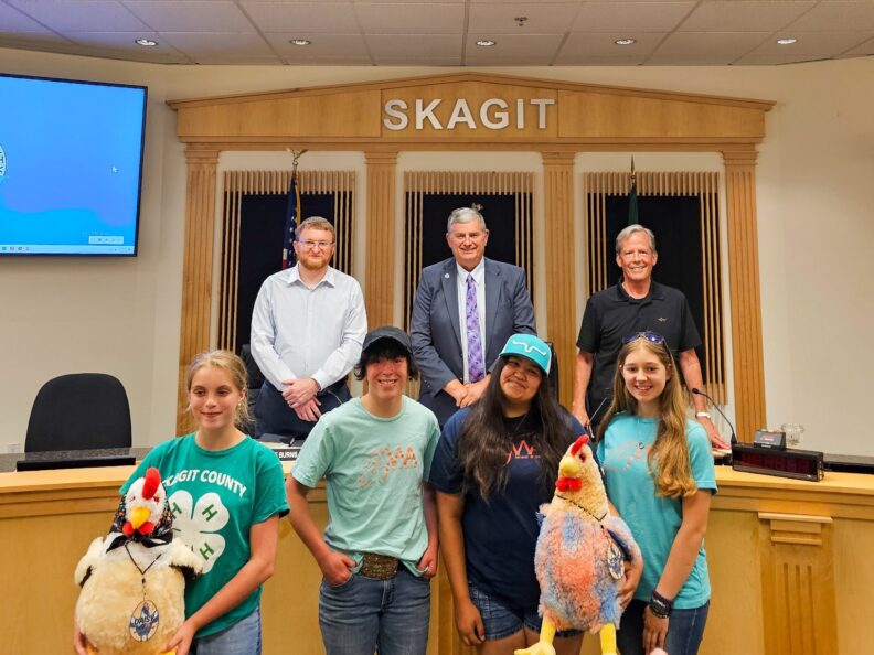 Skagit County 4-H club members standing with Skagit County Commissioners