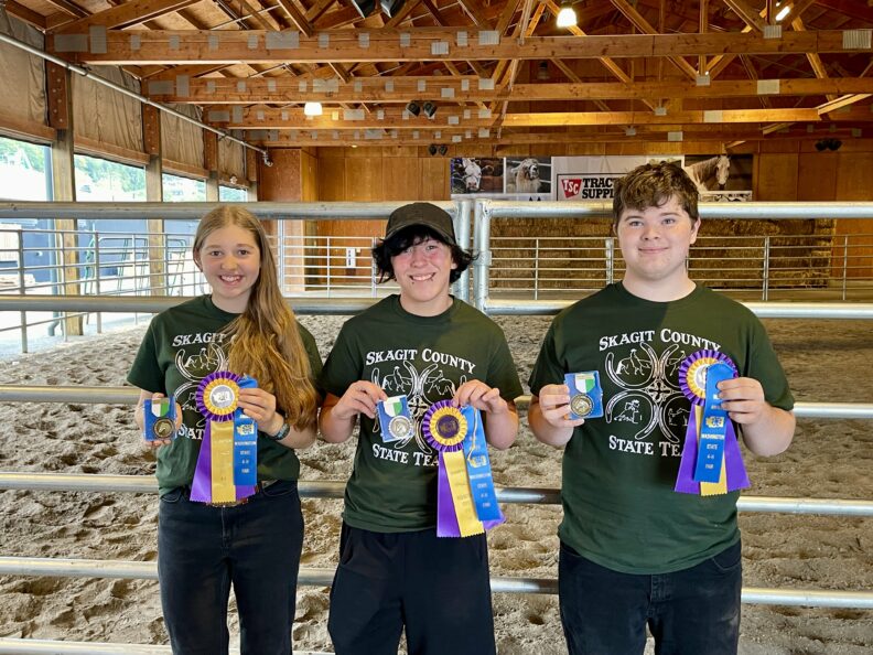Senior Equine Members holding ribbons at State Fair