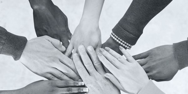 Multiple hands stacked on top each other in a circle. 