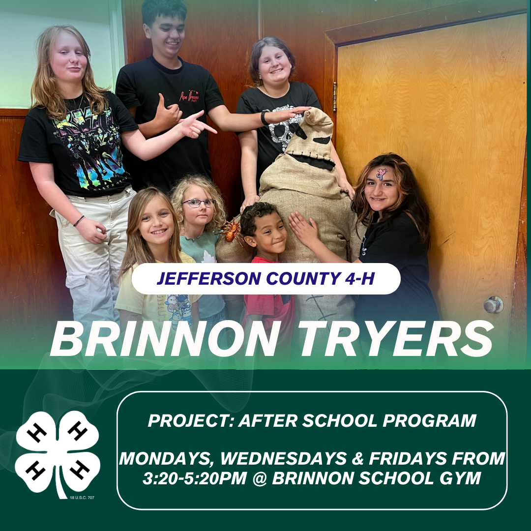 a group of young people standing with a scare crow they made for a competition in Quilcene