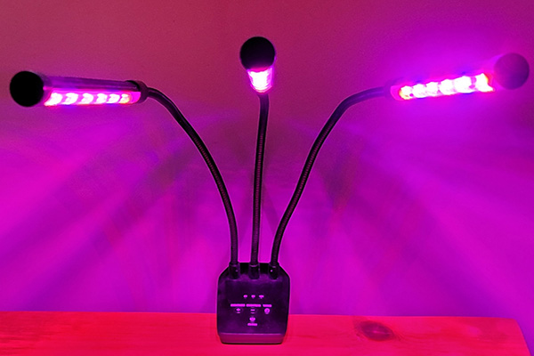 Portable LED light with three adjustable arms.
