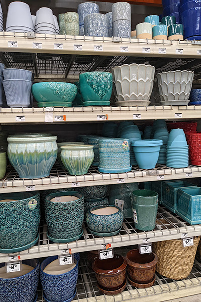 Rows and rows of various plant pots arranged on shelves.