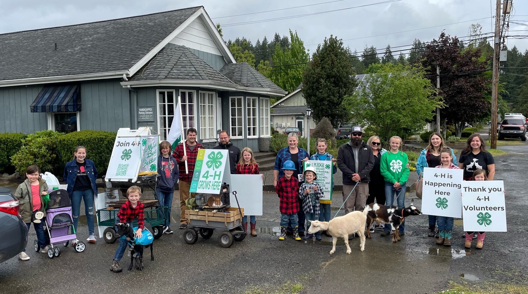 Group of 4-H volunteers in in front of house.
