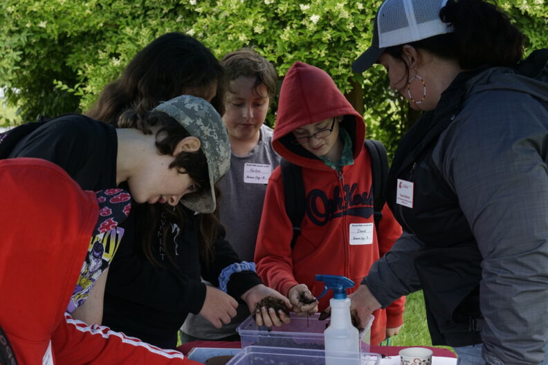 Program Coordinator, Tessa Halloran, teaching Mason County youth about soil science at the annual GreenSTEM Summit.