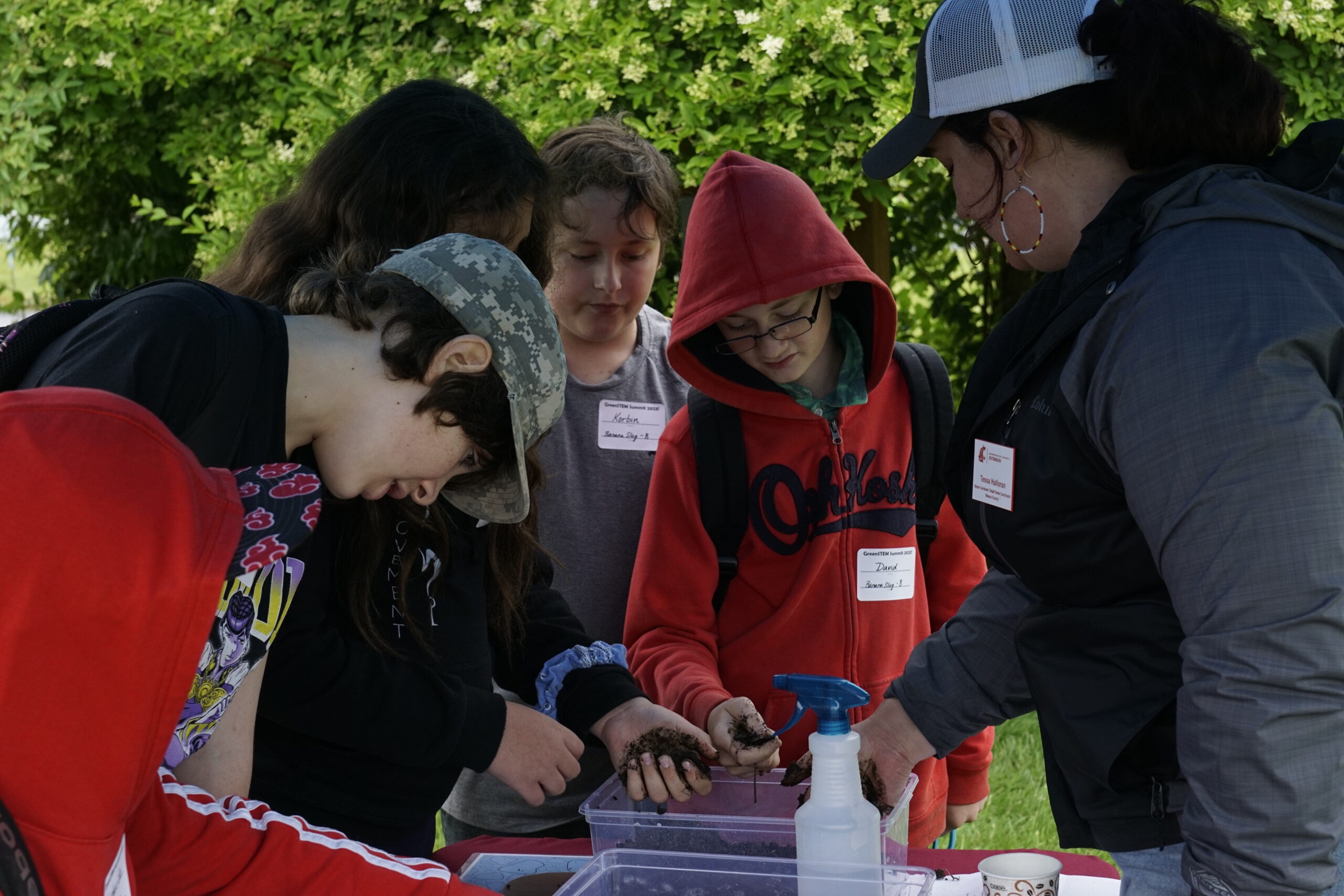Program Coordinator teaching kids about soil science. Link takes you to Small Farms web page.