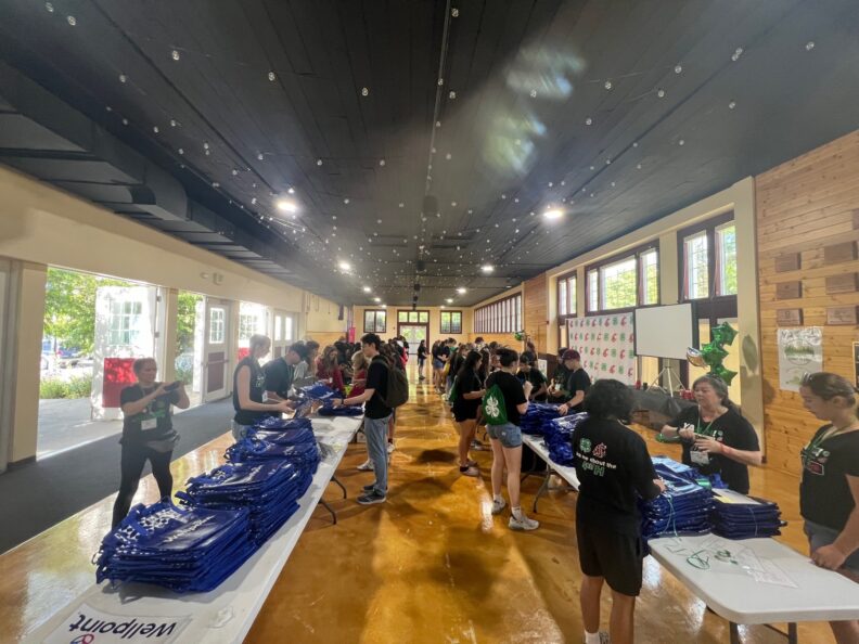 Photos of youth at 4-H Teen Conference stuffing backpacks.