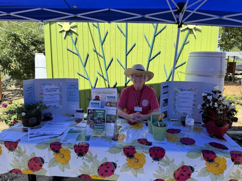 Carol Ann Acocks at check in booth.