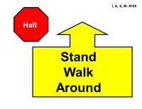 A red octagonal sign labeled “Halt” appears on the left. To the right is a large yellow arrow outlined in black pointing straight upward, attached to a wide rectangular base. Inside the base, bold black text reads “Stand Walk Around.”