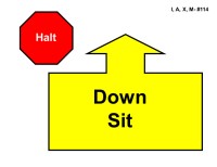 A red octagonal sign labeled “Halt” appears on the left. To the right is a large yellow arrow outlined in black pointing straight upward, attached to a wide rectangular base. Inside the base, bold black text reads “Down Sit.”