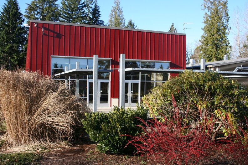 Willis Tucker Park Administrative Office is a red building with a flat roof and large glass windows and doors.
