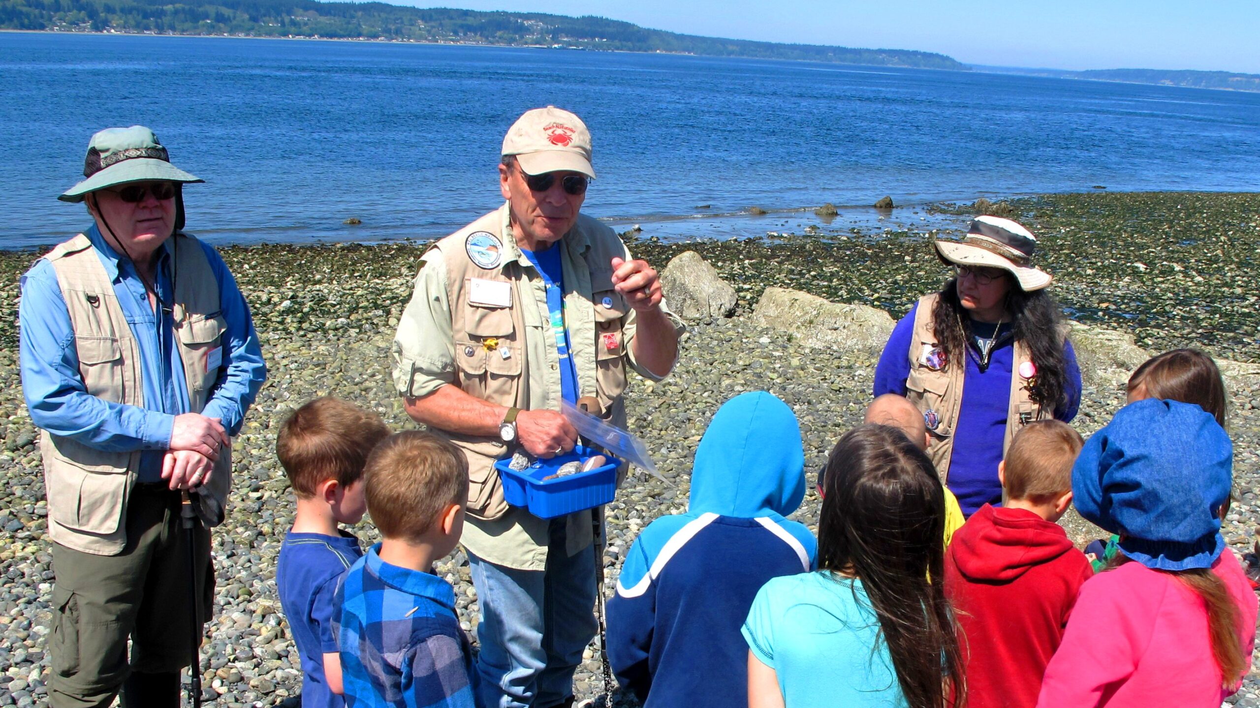 Beach Watchers volunteers talking to grade school kids on beach