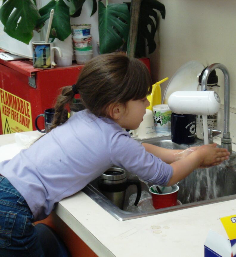 Child washing her hands