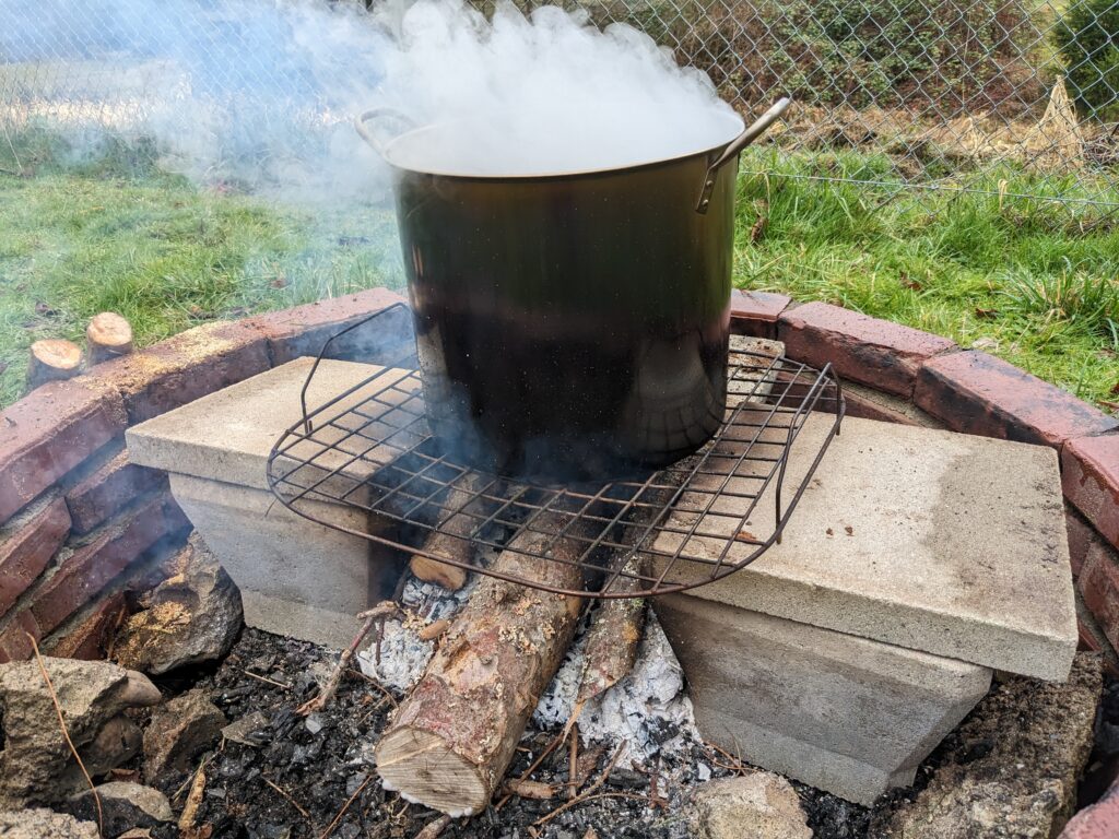 Sap cooking in a stockpot over a campfire.