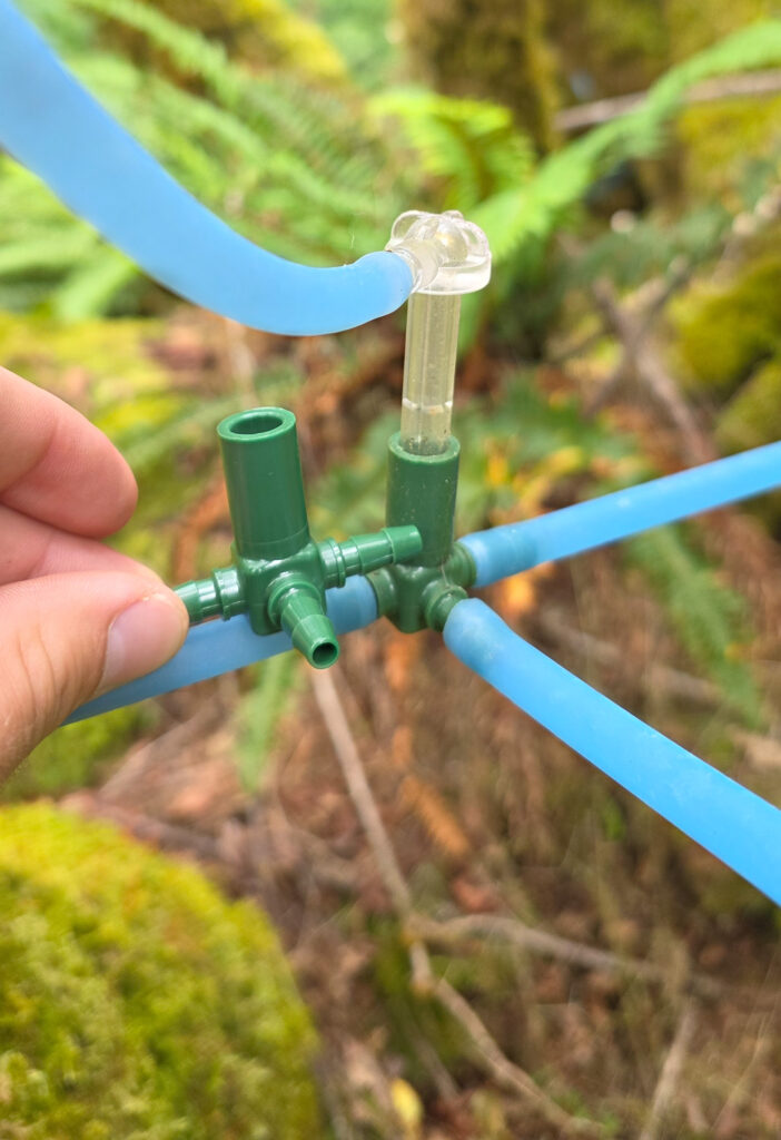 An unused t fitting next to one in use in a tubing system.