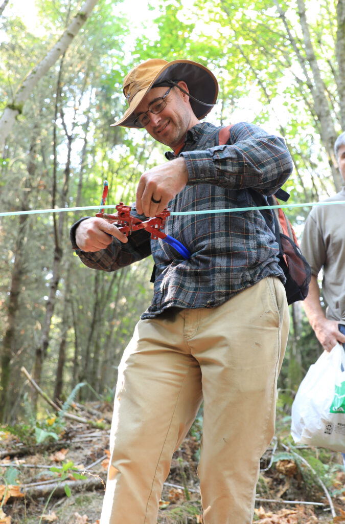 A man uses dropline pliers on a lateral line.