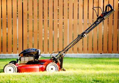 Red lawn mower on grass