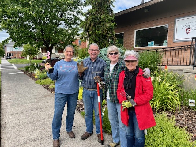Group of 4 Walla Walla County Master Gardeners stand in front of the demonstration garden