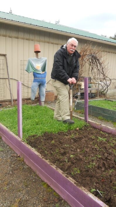 Bob Cain prepares the soil for planting