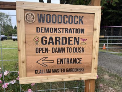 A wooden sign at the entrance of the Woodcock Garden.