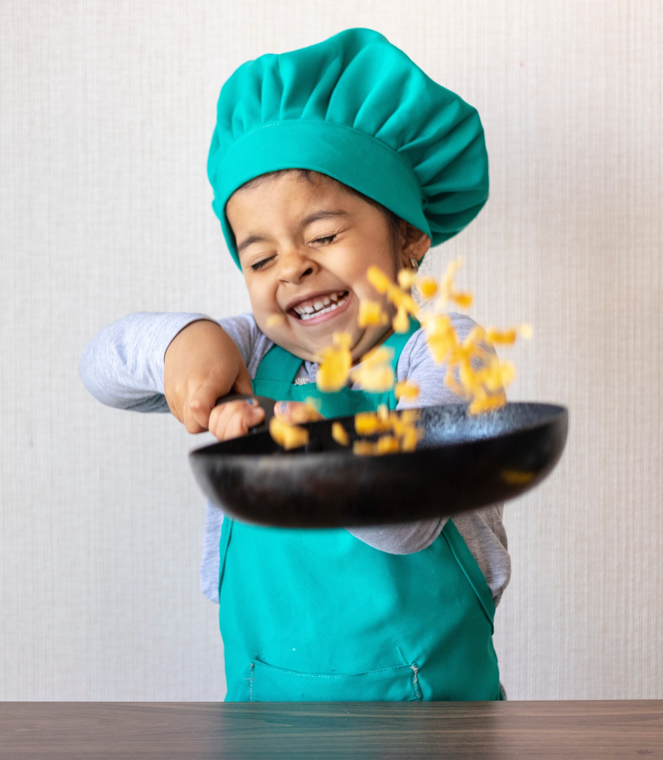 little girl cooking with her frying pan