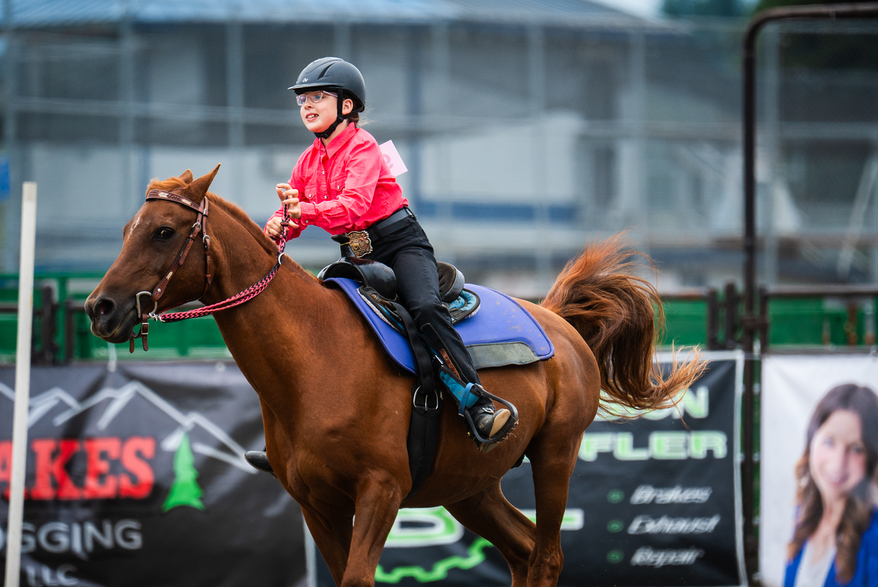 Gwen looking hopeful and happy riding her horse