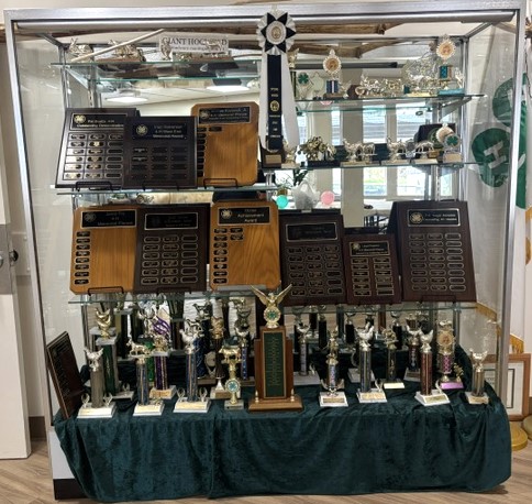 Trophy case full of plaques and trophies
