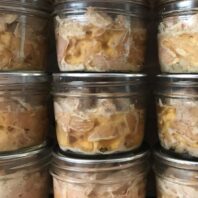 Rows of home-canned tuna in half pint jars